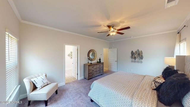 carpeted bedroom featuring multiple windows, ornamental molding, and ceiling fan