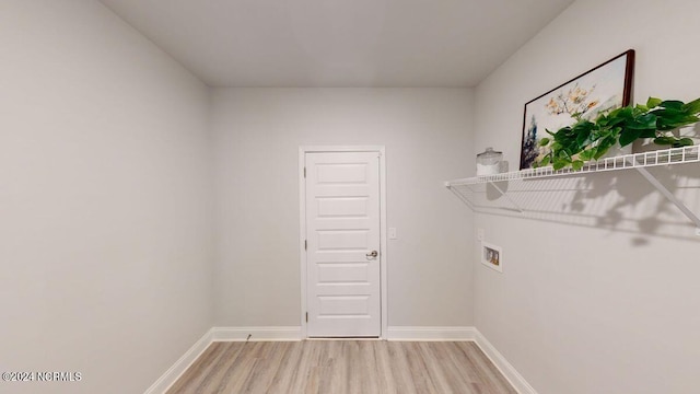 washroom with hardwood / wood-style flooring and hookup for a washing machine