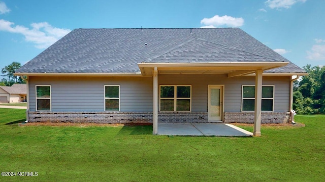 back of house featuring a patio and a lawn