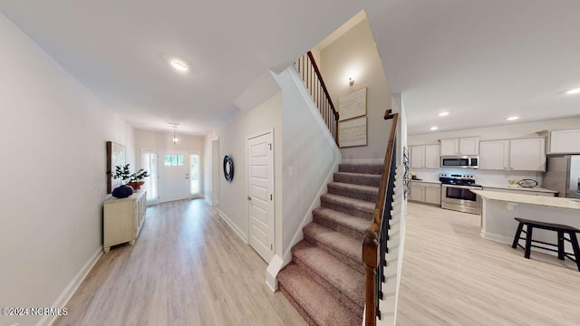 stairway with hardwood / wood-style floors