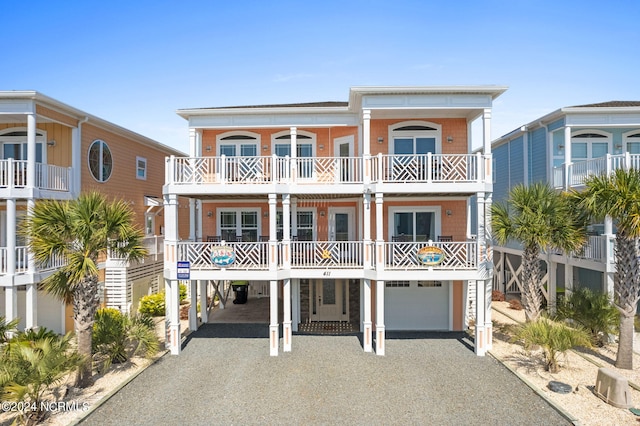 view of front facade featuring a balcony and a garage