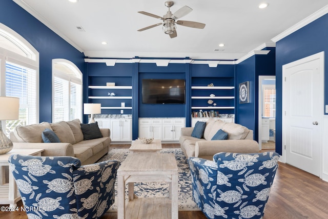 living room with ceiling fan, crown molding, hardwood / wood-style flooring, and built in shelves