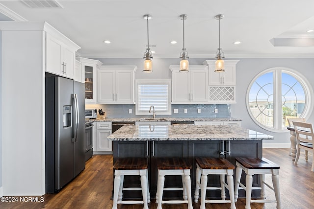 kitchen featuring hanging light fixtures, stainless steel refrigerator with ice dispenser, dark wood-type flooring, sink, and tasteful backsplash