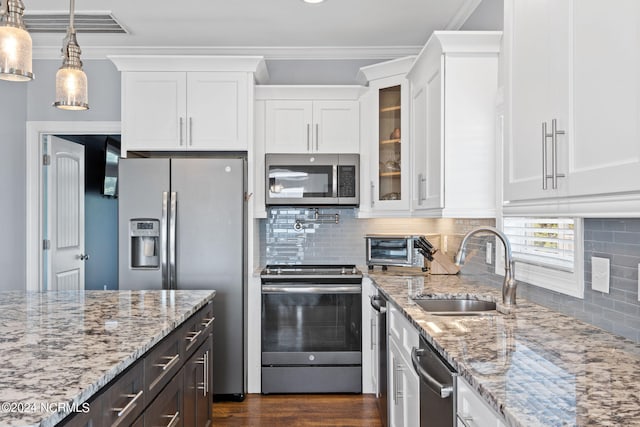 kitchen featuring white cabinets, dark hardwood / wood-style floors, backsplash, appliances with stainless steel finishes, and sink