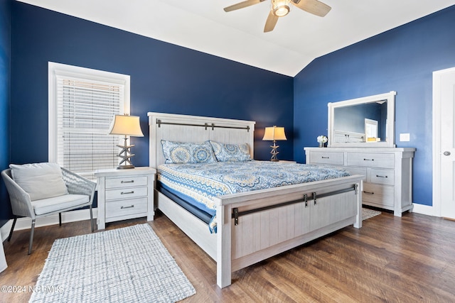 bedroom featuring dark hardwood / wood-style flooring, ceiling fan, and lofted ceiling