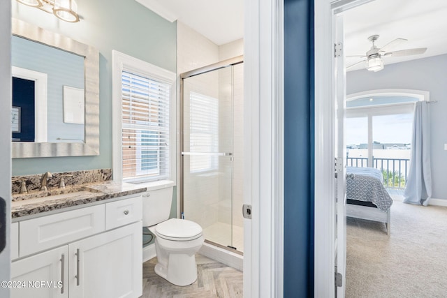 bathroom with a shower with door, ceiling fan, toilet, and vanity