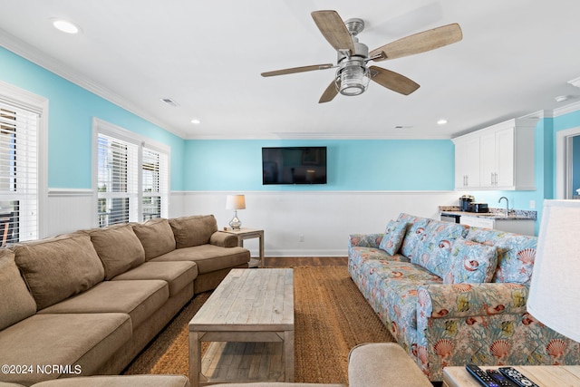 living room featuring ornamental molding, sink, ceiling fan, and dark hardwood / wood-style floors