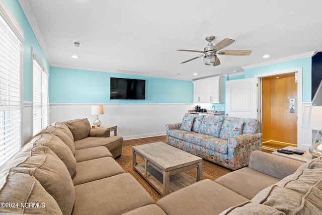 living room featuring sink, crown molding, ceiling fan, and hardwood / wood-style floors