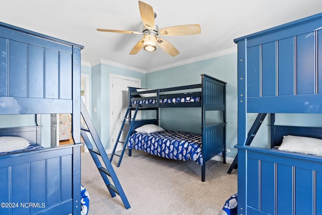 carpeted bedroom with ceiling fan and ornamental molding