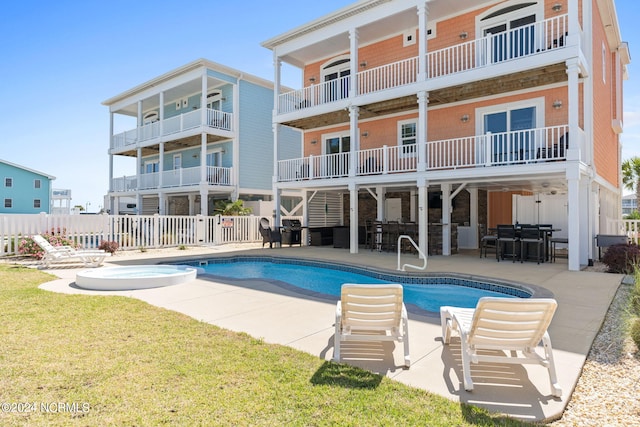 view of pool with a yard and a patio