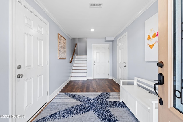 foyer entrance with dark hardwood / wood-style flooring and ornamental molding