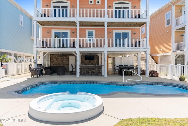 view of swimming pool featuring an in ground hot tub and a patio