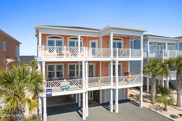 back of house with a carport and a balcony