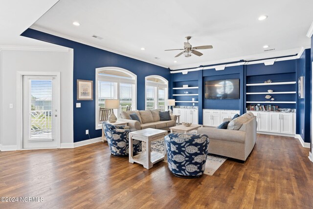 living room featuring dark hardwood / wood-style flooring, ceiling fan, a healthy amount of sunlight, and built in shelves