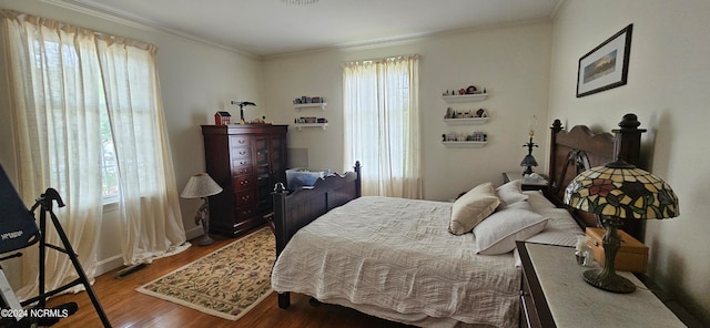 bedroom with hardwood / wood-style flooring and ornamental molding