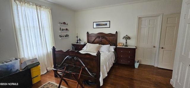 bedroom with ornamental molding, dark hardwood / wood-style flooring, and multiple windows