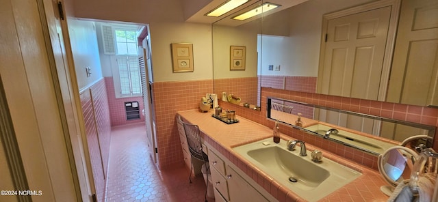 bathroom with backsplash, tile flooring, vanity, and tile walls