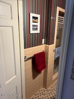 bathroom with tile walls and tile floors