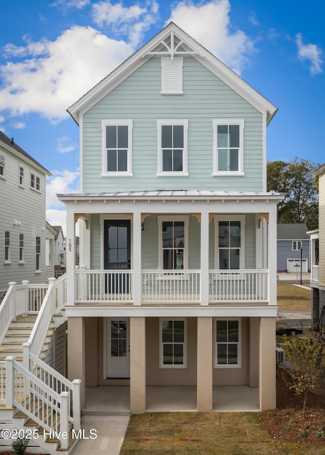 view of front facade with covered porch and a patio