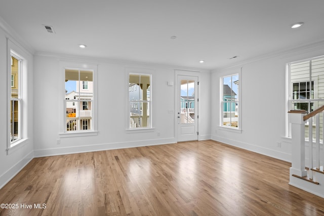 unfurnished living room featuring crown molding and light hardwood / wood-style flooring