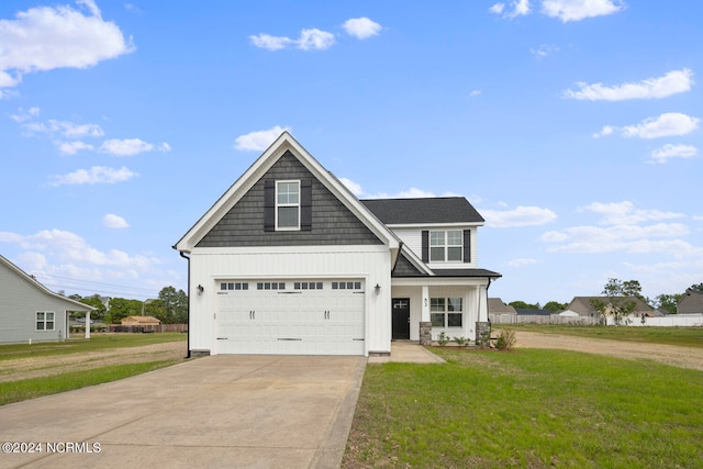 view of front of house with a garage and a front yard