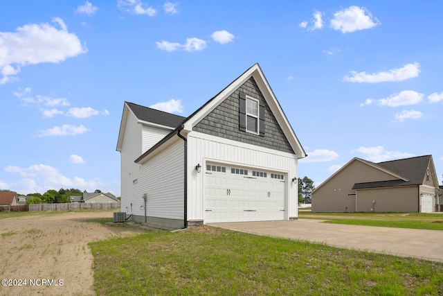 view of property exterior with a garage, a yard, and central air condition unit