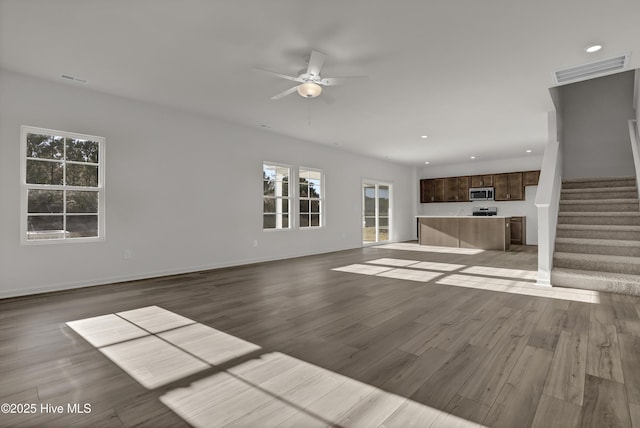 unfurnished living room with ceiling fan and light hardwood / wood-style floors