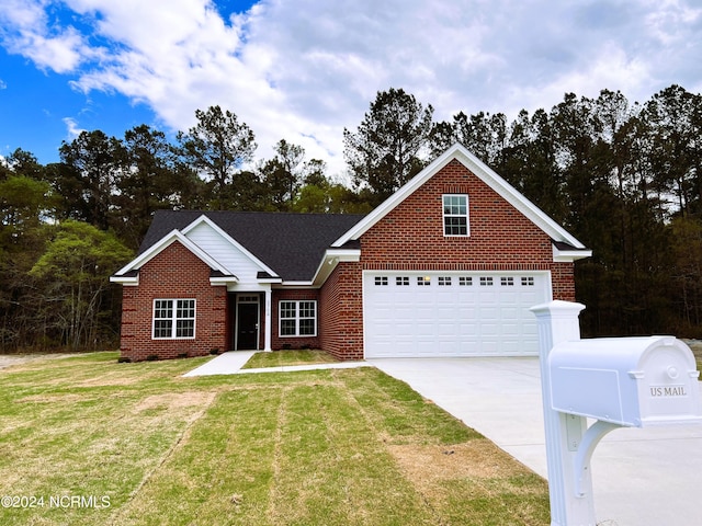 view of front of home featuring a front yard and a garage