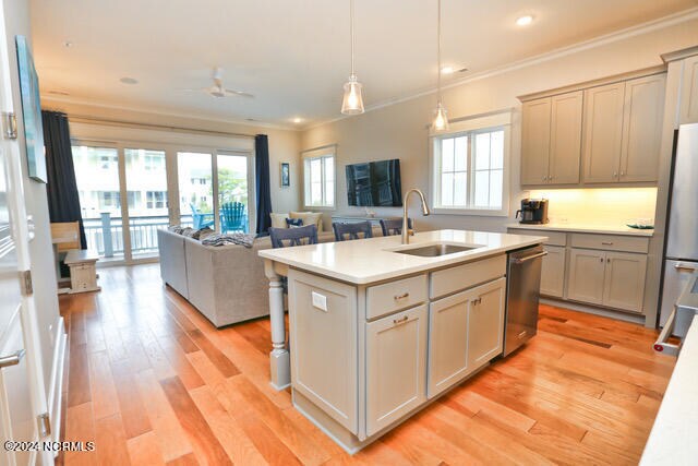 kitchen featuring plenty of natural light, an island with sink, appliances with stainless steel finishes, and sink