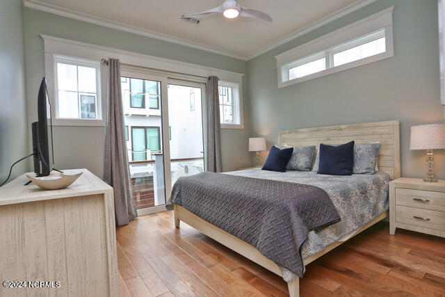 bedroom with ceiling fan, ornamental molding, and light wood-type flooring