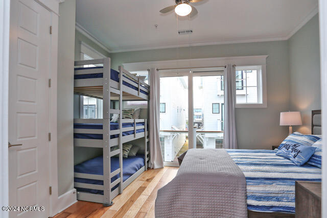 bedroom with light hardwood / wood-style floors, ornamental molding, and ceiling fan