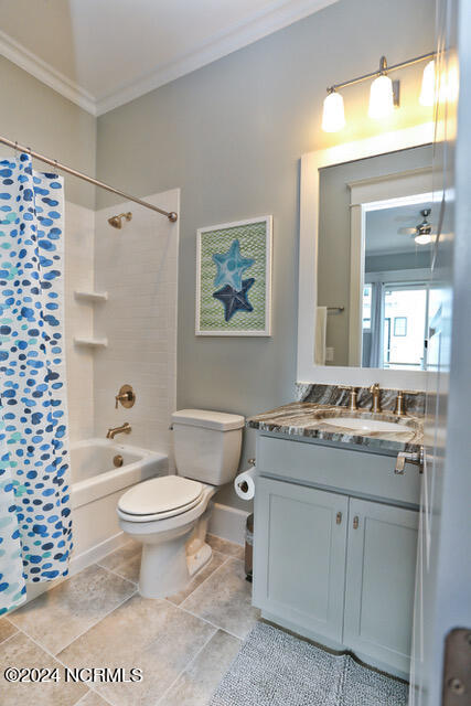 full bathroom with toilet, vanity, ornamental molding, shower / tub combo with curtain, and tile floors