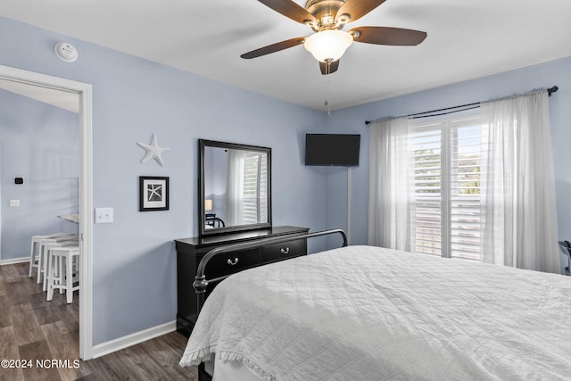 bedroom featuring ceiling fan and dark hardwood / wood-style floors