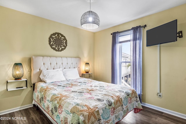 bedroom with dark hardwood / wood-style floors