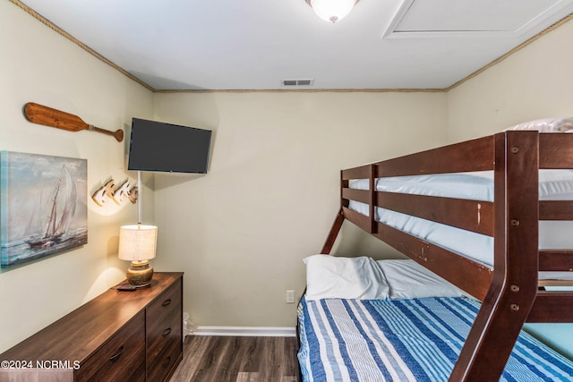 bedroom featuring ornamental molding and dark wood-type flooring