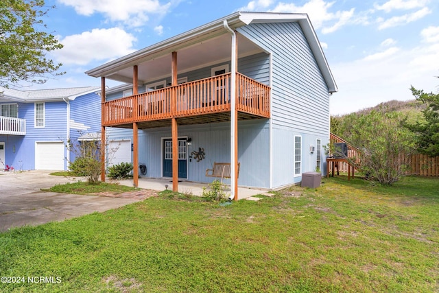 exterior space with a deck, a lawn, and a garage