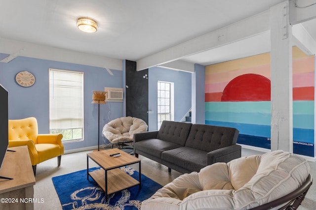 living room featuring beam ceiling and a wall mounted AC