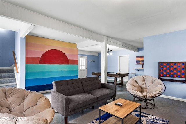 living room with beamed ceiling and concrete flooring