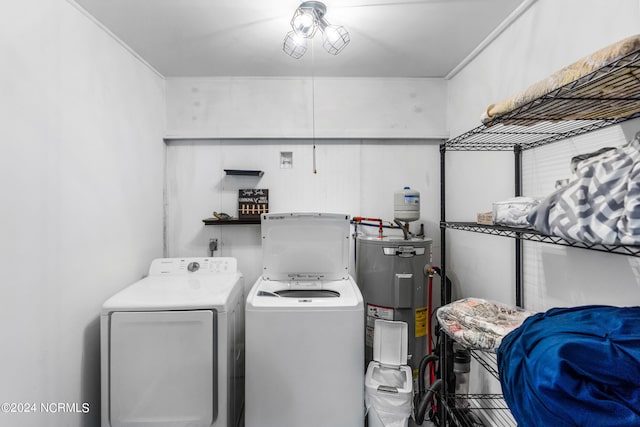 laundry room featuring ornamental molding, water heater, and washer and dryer