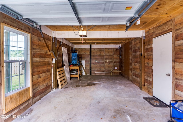 garage featuring wood walls and a garage door opener