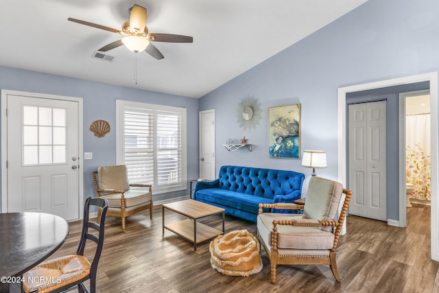 living room featuring a healthy amount of sunlight, dark hardwood / wood-style flooring, and lofted ceiling