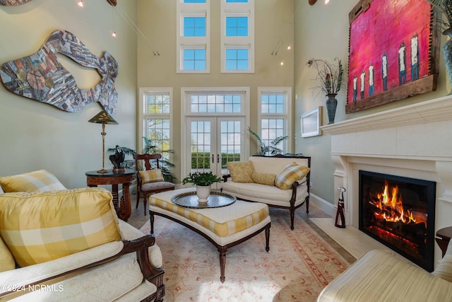 living room featuring french doors and a high ceiling