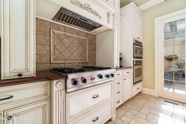 kitchen featuring premium range hood, appliances with stainless steel finishes, light tile floors, and crown molding