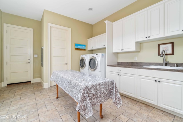 laundry area featuring cabinets, independent washer and dryer, sink, and light tile flooring