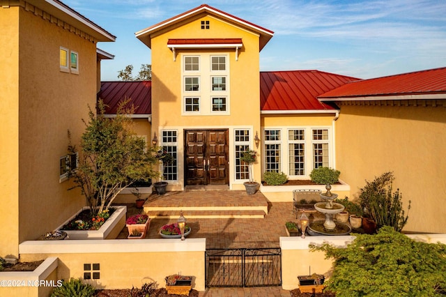 back of property featuring a patio area and french doors