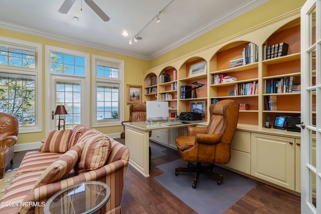 office with dark hardwood / wood-style floors, built in desk, track lighting, ceiling fan, and ornamental molding