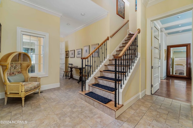 stairway featuring light tile floors and ornamental molding