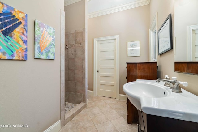 bathroom with ornamental molding, tile flooring, a tile shower, and vanity