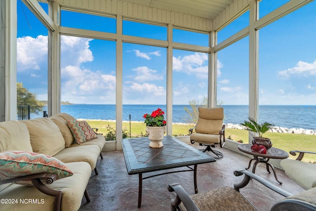 sunroom / solarium with a water view