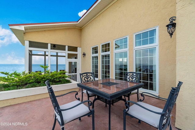 view of terrace with a water view